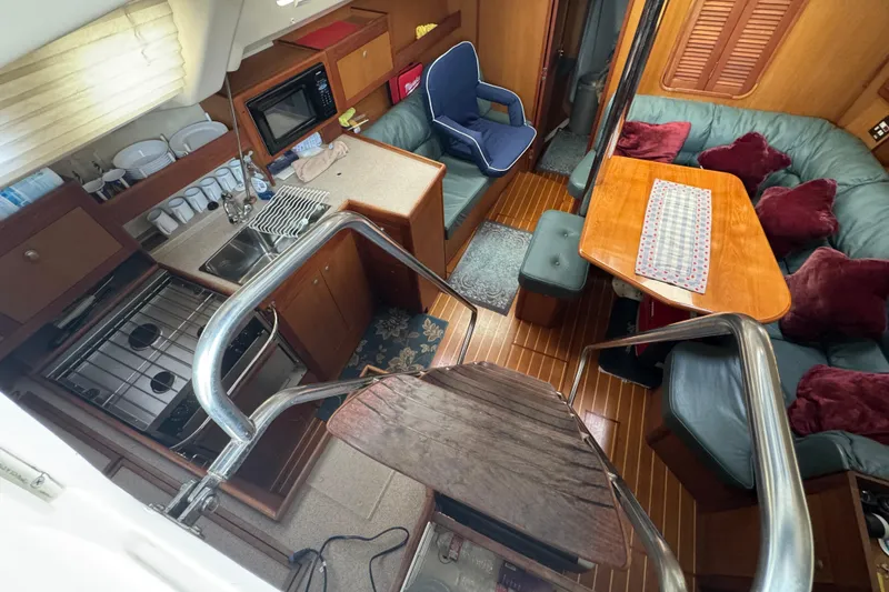 Slide: The Image of Interior of 1999 Hunter Passage 420 yacht with kitchen and seating area. - 25