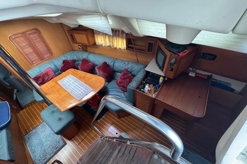 Slide: The Image of Interior of 1999 Hunter Passage 420 yacht with cozy seating and wooden furnishings. - 26