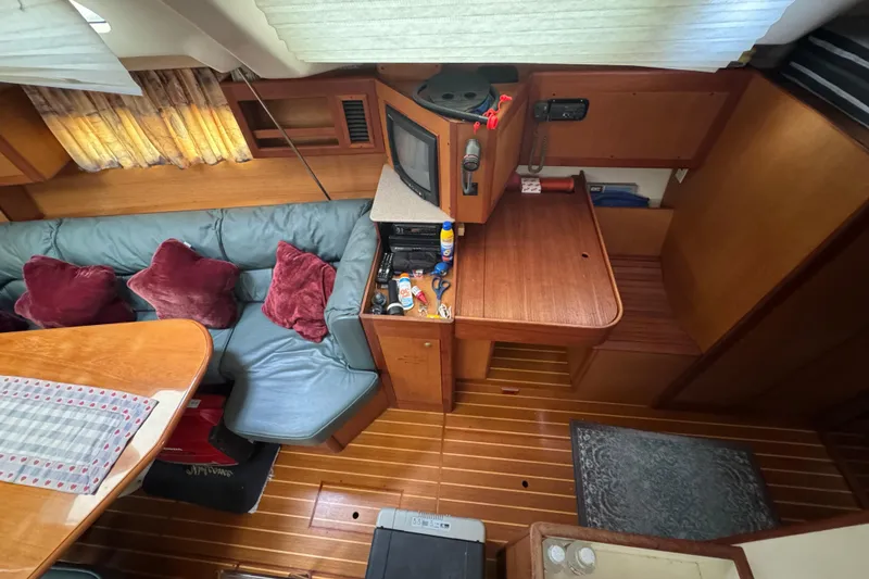 Slide: The Image of Interior of 1999 Hunter Passage 420 yacht with cozy seating and wooden furnishings. - 27