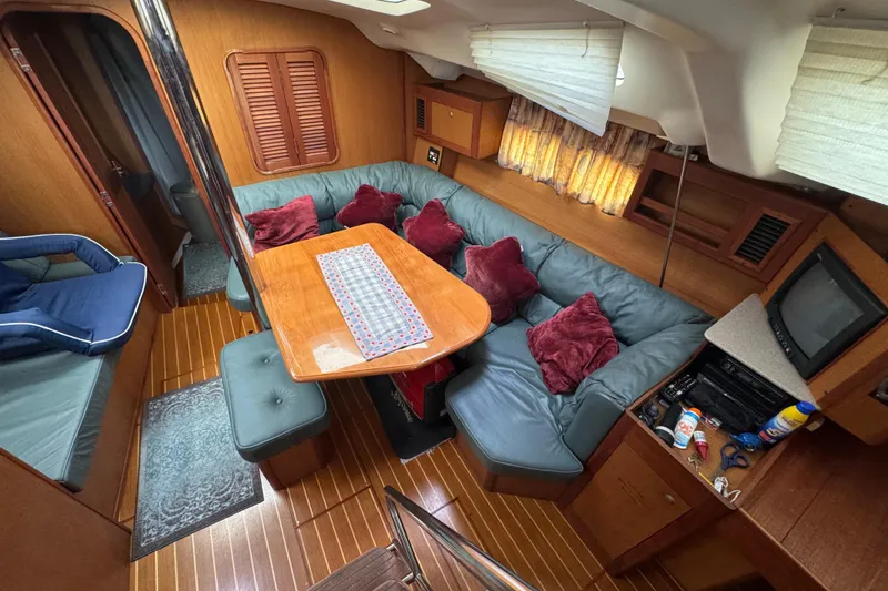 Slide: The Image of Interior of 1999 Hunter Passage 420 yacht with cozy seating and wooden finishes. - 28
