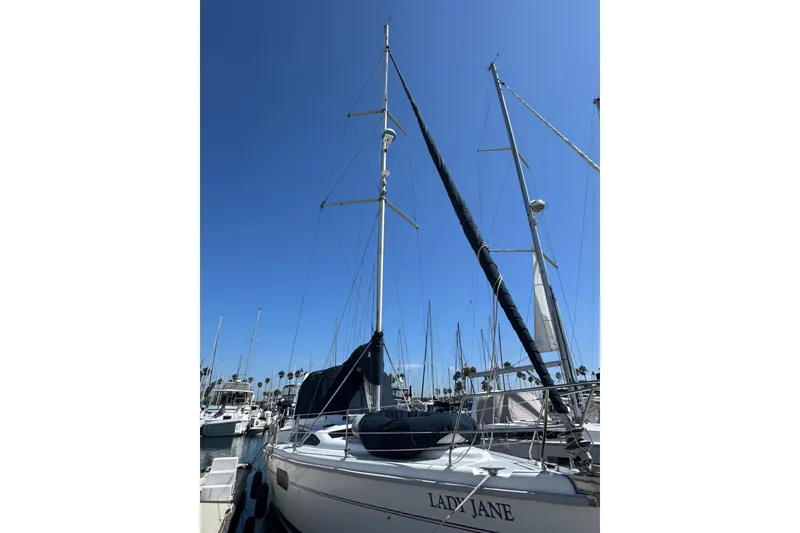 Slide: The Image of 1999 Hunter Passage 420 sailboat docked under clear blue sky. - 3