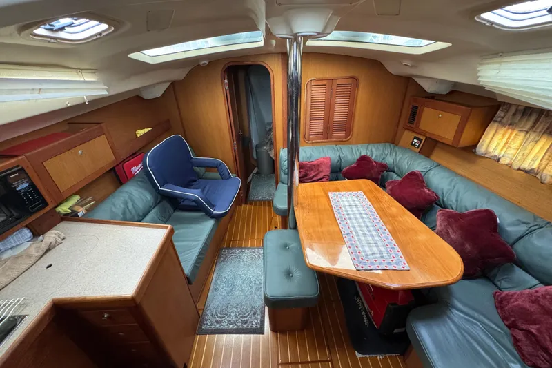 Slide: The Image of Interior of 1999 Hunter Passage 420 yacht with cozy seating and wooden finishes. - 31