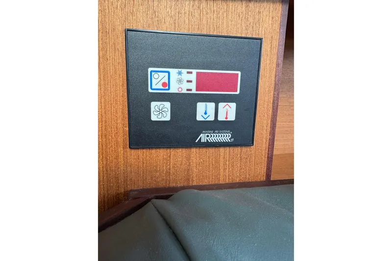 Slide: The Image of Control panel of a 1999 Hunter Passage 420 yacht, featuring temperature and fan settings. - 32