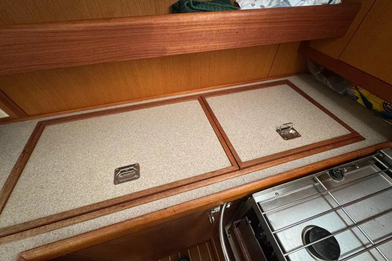 Slide: The Image of 1999 Hunter Passage 420 yacht interior with wooden cabinetry and stove. - 39