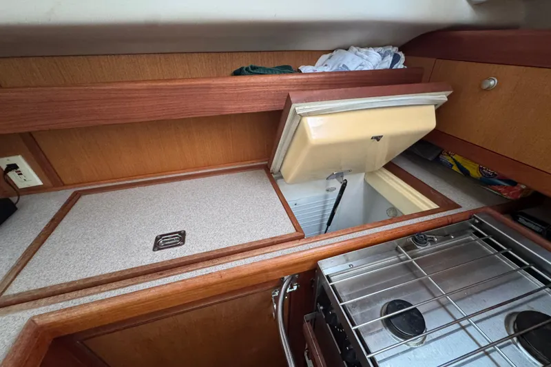 Slide: The Image of 1999 Hunter Passage 420 yacht kitchen with open fridge and stove. - 40
