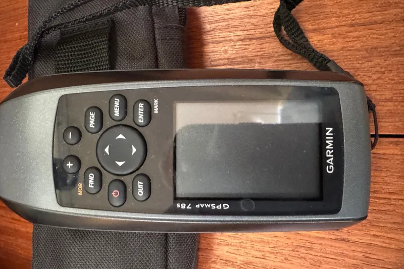 Slide: The Image of Handheld Garmin GPSMAP 76S device on wooden surface, associated with 1999 Hunter Passage 420. - 52