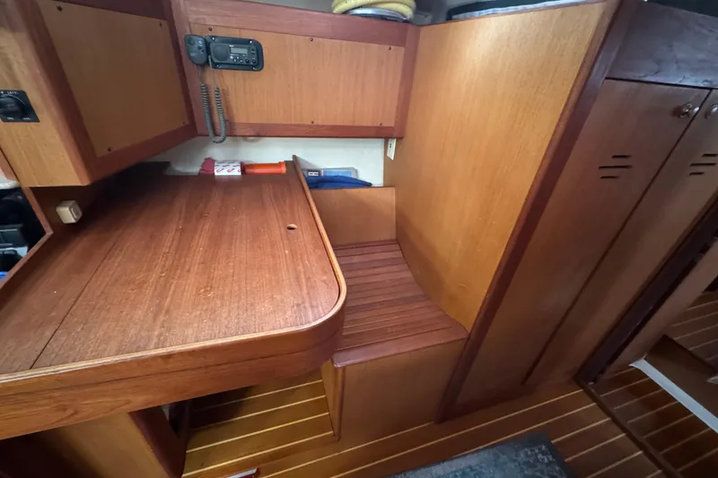 Slide: The Image of Interior of 1999 Hunter Passage 420 sailboat with wooden cabinetry and navigation station. - 53