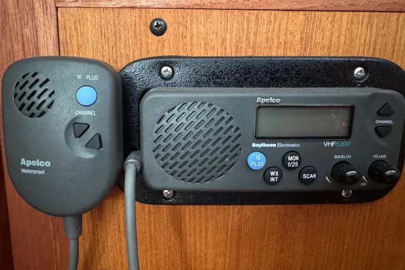 Slide: The Image of VHF radio system on 1999 Hunter Passage 420 sailboat, featuring Apelco waterproof microphone. - 54