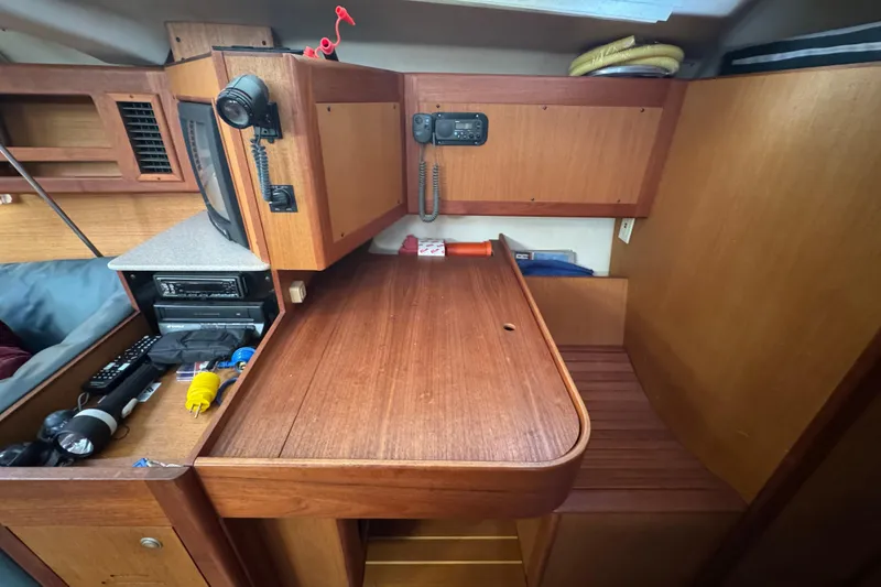 Slide: The Image of Interior of 1999 Hunter Passage 420 sailboat with wooden cabinetry and navigation equipment. - 55