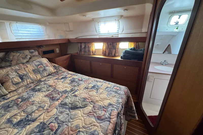 Slide: The Image of Cozy cabin interior of 1999 Hunter Passage 420 yacht with bed and ensuite bathroom. - 66