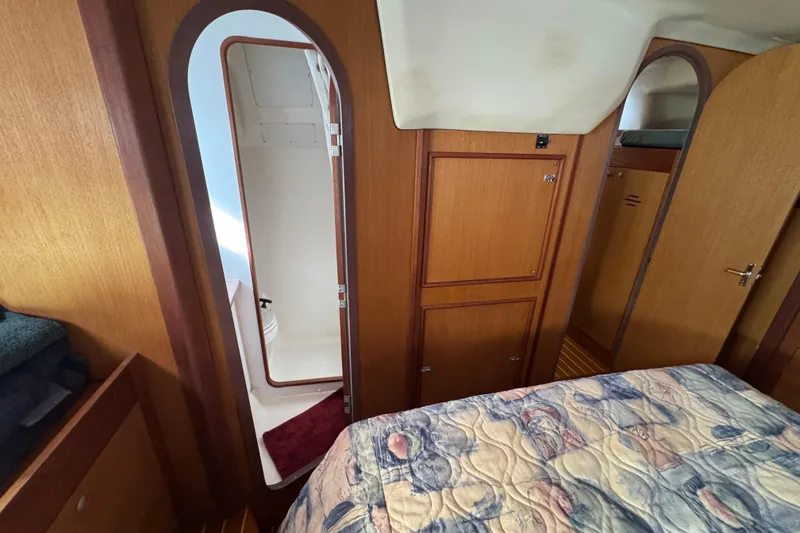 Slide: The Image of Interior of 1999 Hunter Passage 420 yacht, featuring wood paneling and a cozy cabin. - 67