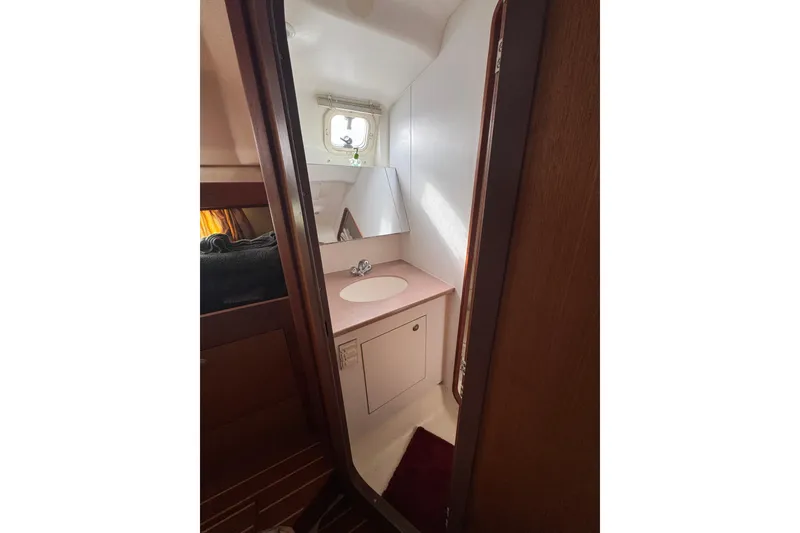 Slide: The Image of Compact bathroom in 1999 Hunter Passage 420 sailboat with sink and mirror. - 68