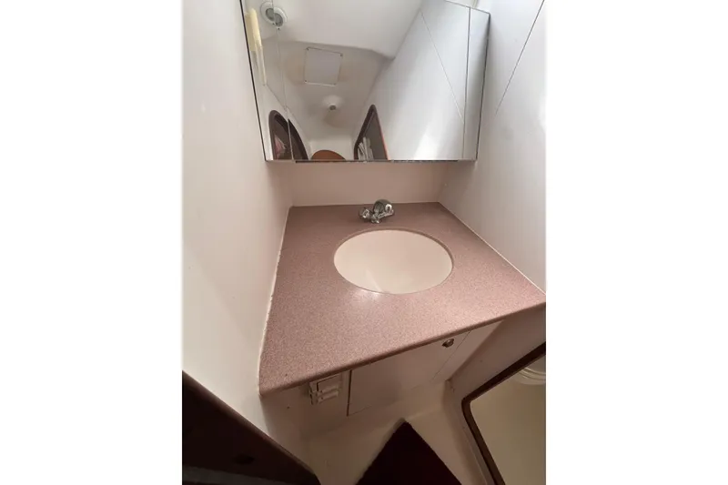 Slide: The Image of Bathroom vanity in 1999 Hunter Passage 420 yacht with mirror and sink. - 69