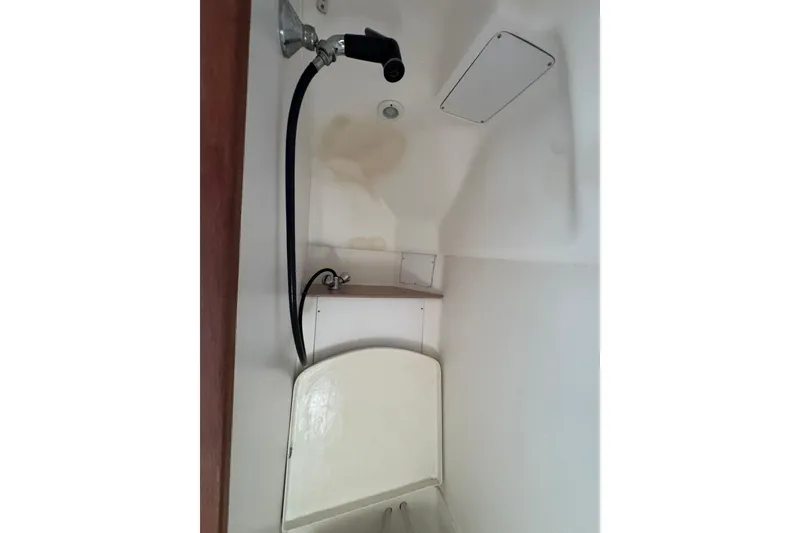 Slide: The Image of Shower area in 1999 Hunter Passage 420 sailboat, featuring a handheld showerhead. - 71