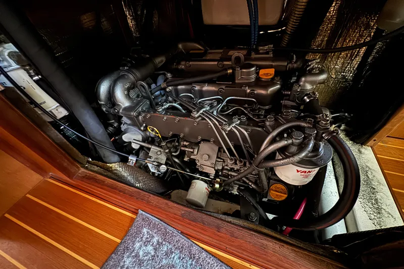 Slide: The Image of Engine compartment of a 1999 Hunter Passage 420 sailboat, showcasing detailed mechanical components. - 76