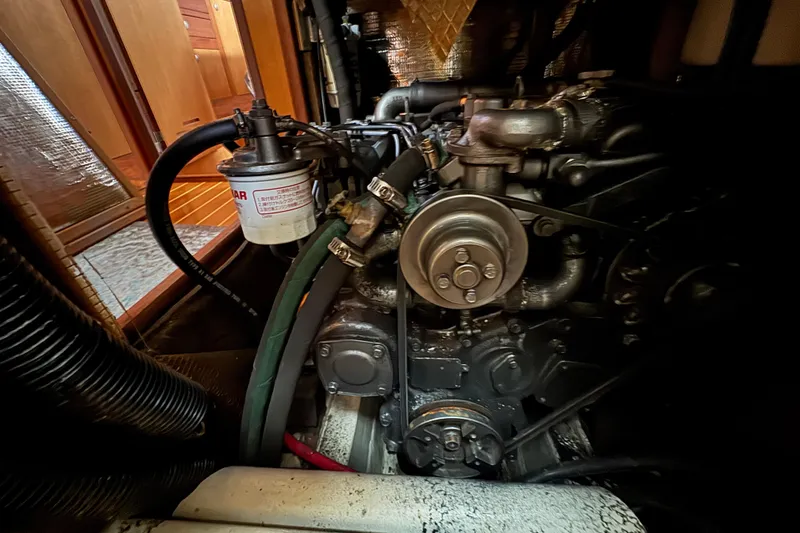 Slide: The Image of Engine compartment of a 1999 Hunter Passage 420 sailboat, showcasing mechanical components. - 78