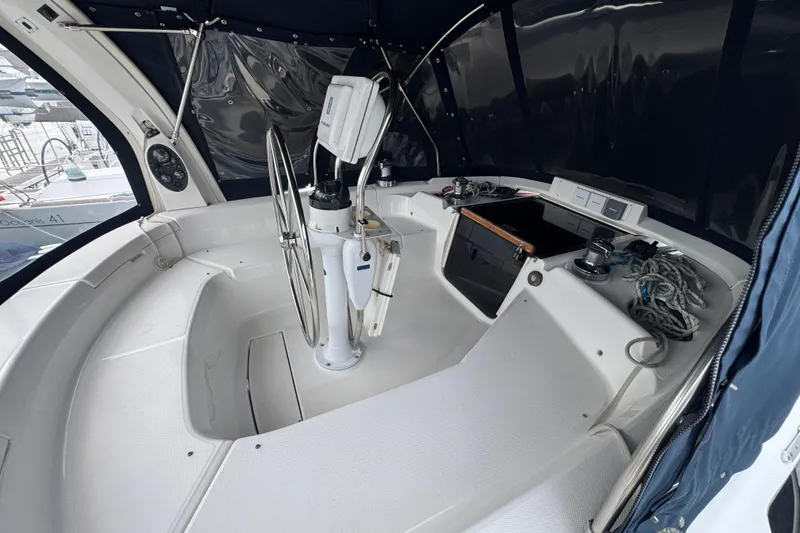 Slide: The Image of Cockpit of 1999 Hunter Passage 420 sailboat with steering wheel and navigation equipment. - 81