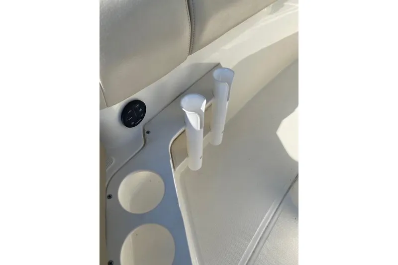 Slide: The Image of Interior of 2021 Boston Whaler 230 Outrage featuring cup holders and rod holders. - 11