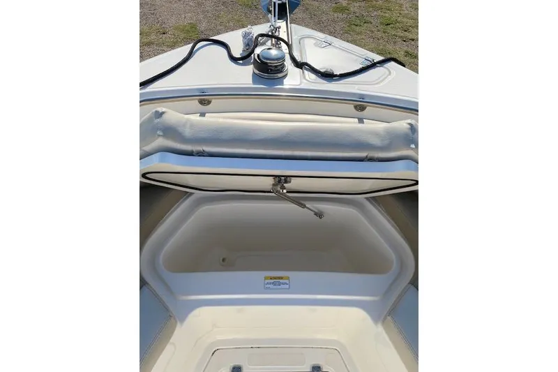 Slide: The Image of 2021 Boston Whaler 230 Outrage boat storage compartment open, showcasing interior space. - 15