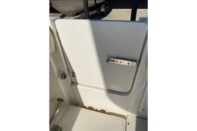 Slide: The Image of 2021 Boston Whaler 230 Outrage boat interior door with latch, white finish. - 16