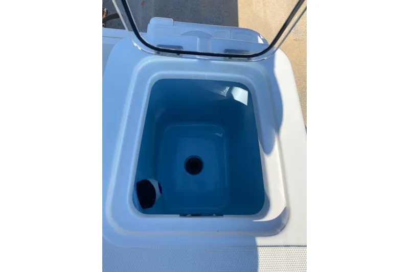 Slide: The Image of Open storage compartment on 2021 Boston Whaler 230 Outrage boat. - 17