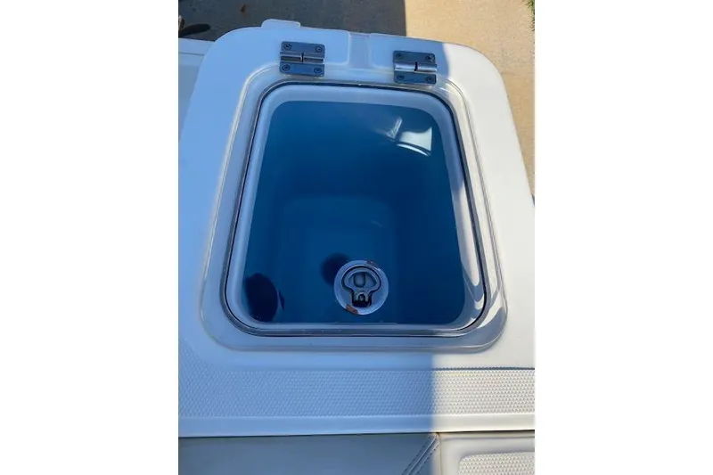 Slide: The Image of Livewell on 2021 Boston Whaler 230 Outrage boat, featuring a clear lid and blue interior. - 18