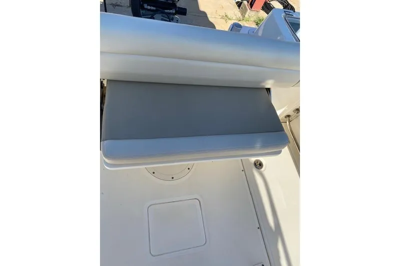 Slide: The Image of 2021 Boston Whaler 230 Outrage boat seat, gray cushion, white deck. - 20