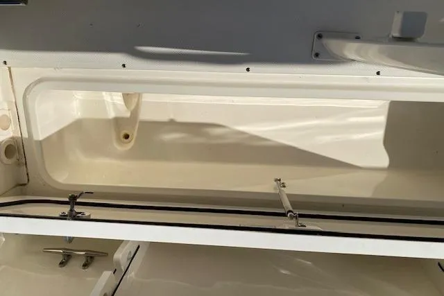 Slide: The Image of Open storage compartment on a 2021 Boston Whaler 230 Outrage boat. - 23