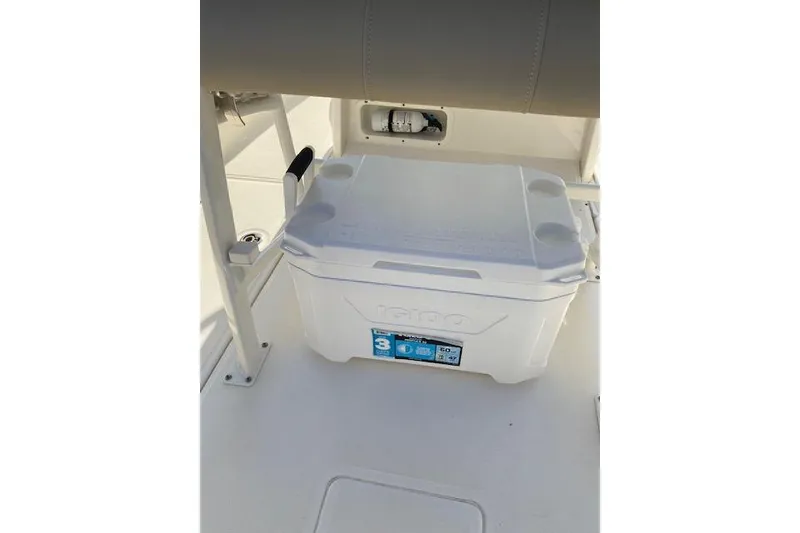 Slide: The Image of White cooler on a 2021 Boston Whaler 230 Outrage boat deck. - 24