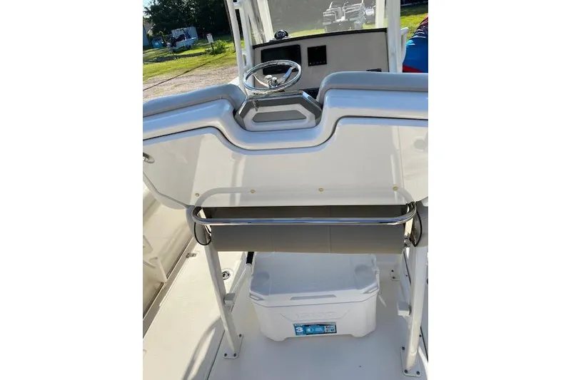 Slide: The Image of 2021 Boston Whaler 230 Outrage boat console with steering wheel and storage area. - 28