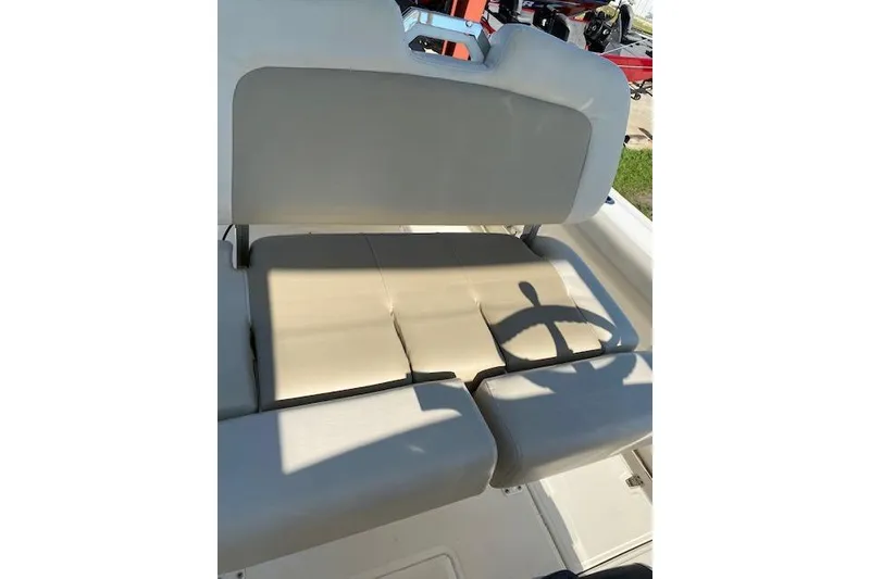 Slide: The Image of 2021 Boston Whaler 230 Outrage boat seating area with beige cushions. - 29