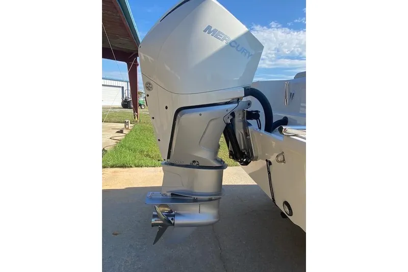 Slide: The Image of Outboard motor of a 2021 Boston Whaler 230 Outrage boat, parked outdoors. - 3