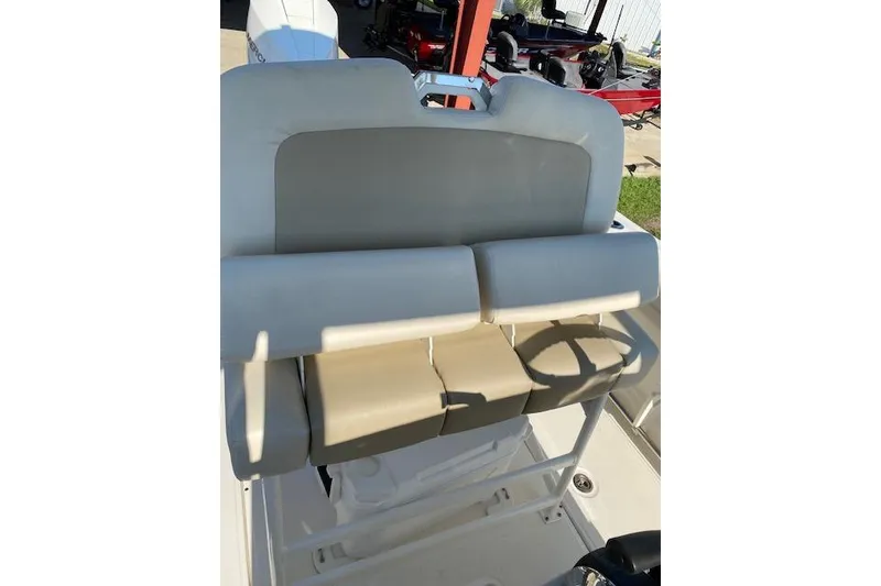 Slide: The Image of 2021 Boston Whaler 230 Outrage boat interior with beige seating and steering wheel. - 30