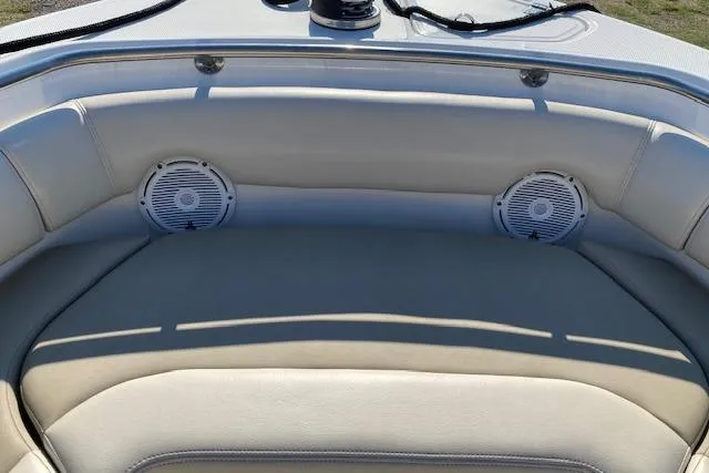 Slide: The Image of 2021 Boston Whaler 230 Outrage boat interior with cushioned seating and built-in speakers. - 33