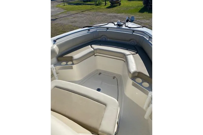 Slide: The Image of 2021 Boston Whaler 230 Outrage boat interior with cushioned seating and storage compartments. - 35