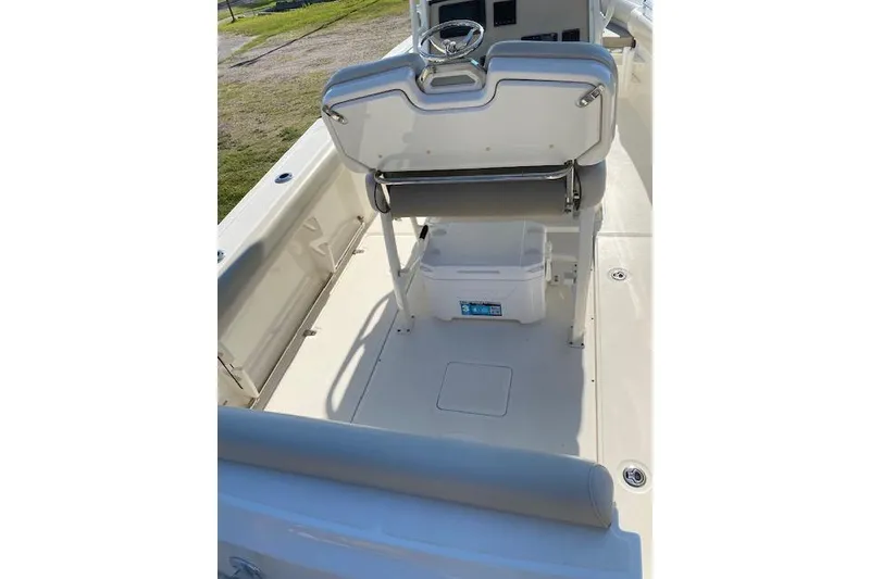 Slide: The Image of 2021 Boston Whaler 230 Outrage boat interior with seating and storage area. - 6