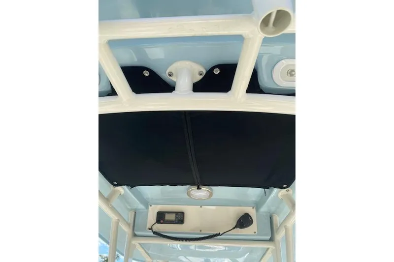 Slide: The Image of 2021 Boston Whaler 230 Outrage boat interior, featuring a control panel and overhead structure. - 8