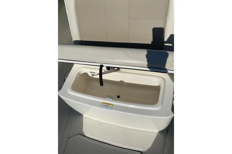 Slide: The Image of Boston Whaler 230 Outrage 2021 boat seat with storage compartment open. - 9