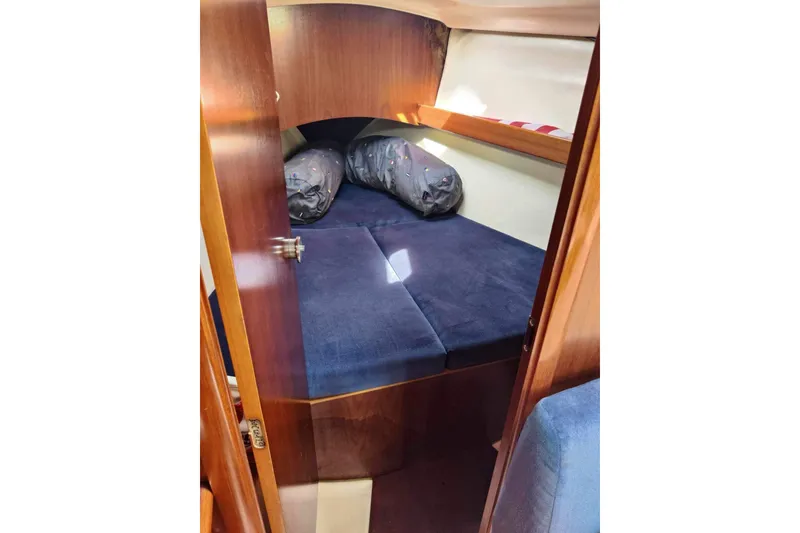 Slide: The Image of Cozy cabin interior of 1998 Beneteau Oceanis 352 sailboat with blue bedding. - 18