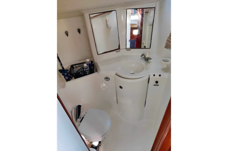 Slide: The Image of Bathroom of 1998 Beneteau Oceanis 352 sailboat with sink, mirror, and toilet. - 20