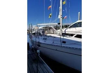 Slide: The Image of 1998 Beneteau Oceanis 352 sailboat docked, flags on mast, clear blue sky. - 3