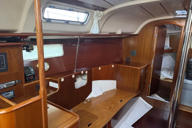 Slide: The Image of Interior of 1998 Beneteau Oceanis 352 sailboat with wooden cabinetry and seating area. - 30