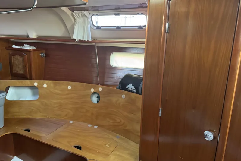 Slide: The Image of Interior of 1998 Beneteau Oceanis 352 sailboat with wooden cabinetry and porthole window. - 31