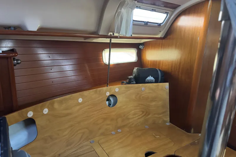 Slide: The Image of Interior cabin of 1998 Beneteau Oceanis 352 sailboat with wooden paneling and porthole. - 32