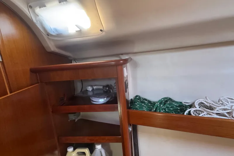 Slide: The Image of Interior of 1998 Beneteau Oceanis 352 sailboat with ropes and storage shelves. - 35