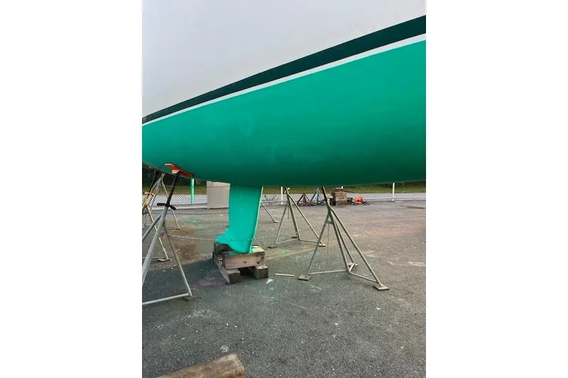 Slide: The Image of 1998 Beneteau Oceanis 352 sailboat hull on stands, vibrant teal color. - 39