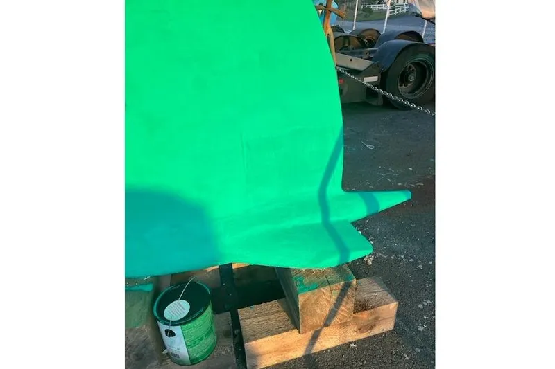 Slide: The Image of Green-painted keel of a 1998 Beneteau Oceanis 352 sailboat on wooden blocks. - 41