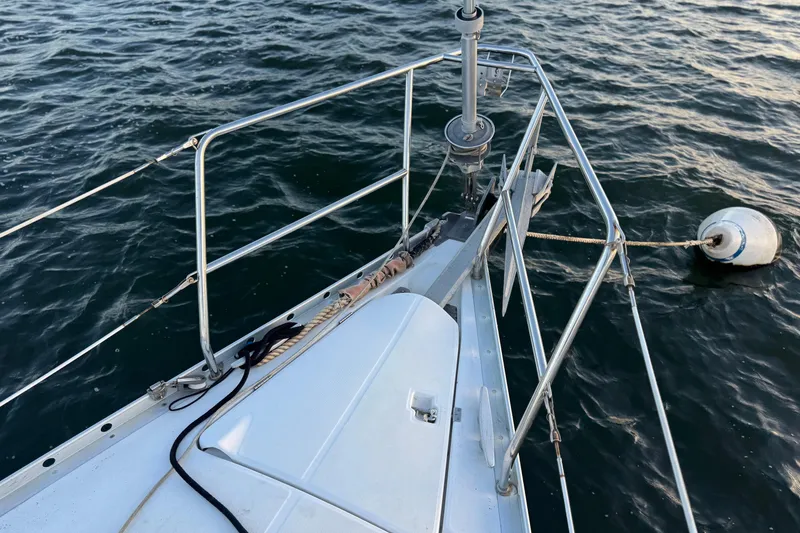 Slide: The Image of Bow of 1998 Beneteau Oceanis 352 sailboat with mooring buoy on water. - 8