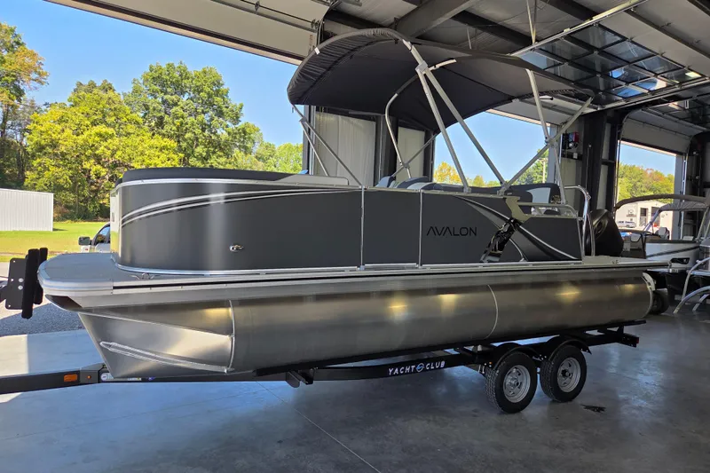 The Image of 2026 Avalon LSZ 2185 Cruise Rear Bench pontoon boat in a garage setting. - 0