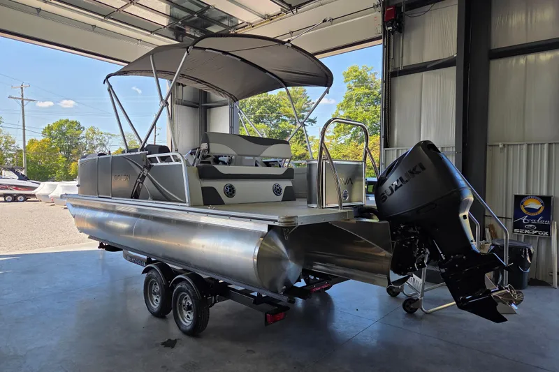 Slide: The Image of 2026 Avalon LSZ 2185 Cruise Rear Bench pontoon boat in a garage setting. - 3